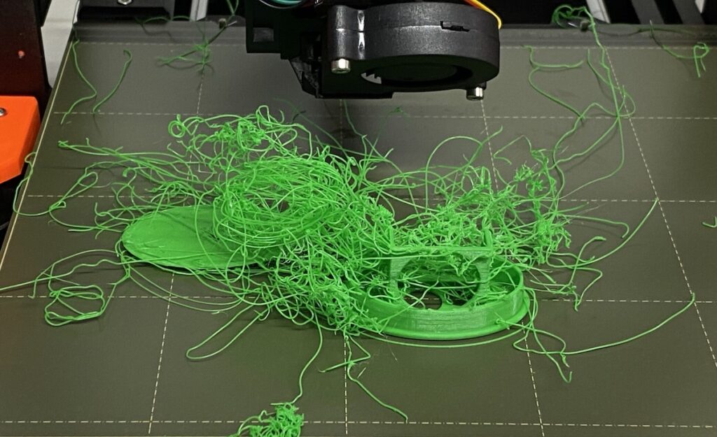 a scribbly mess of 3D printing filament from a print that went very wrong
